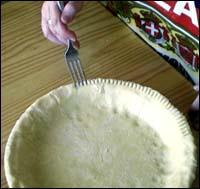Crimping the dough edges with a fork